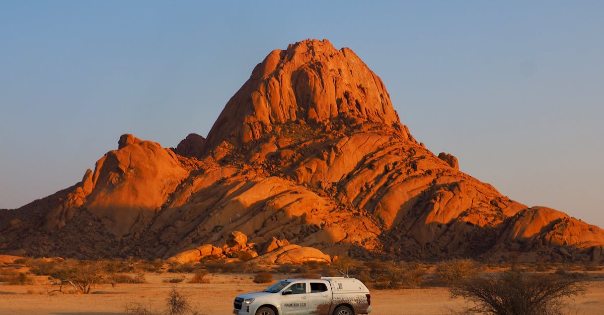 Spitzkoppe at sunset with a car in the foreground